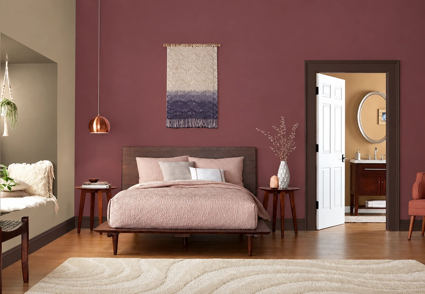 A bedroom colour concept with burgundy walls, taupe relief, dark trim and a copper pendant.